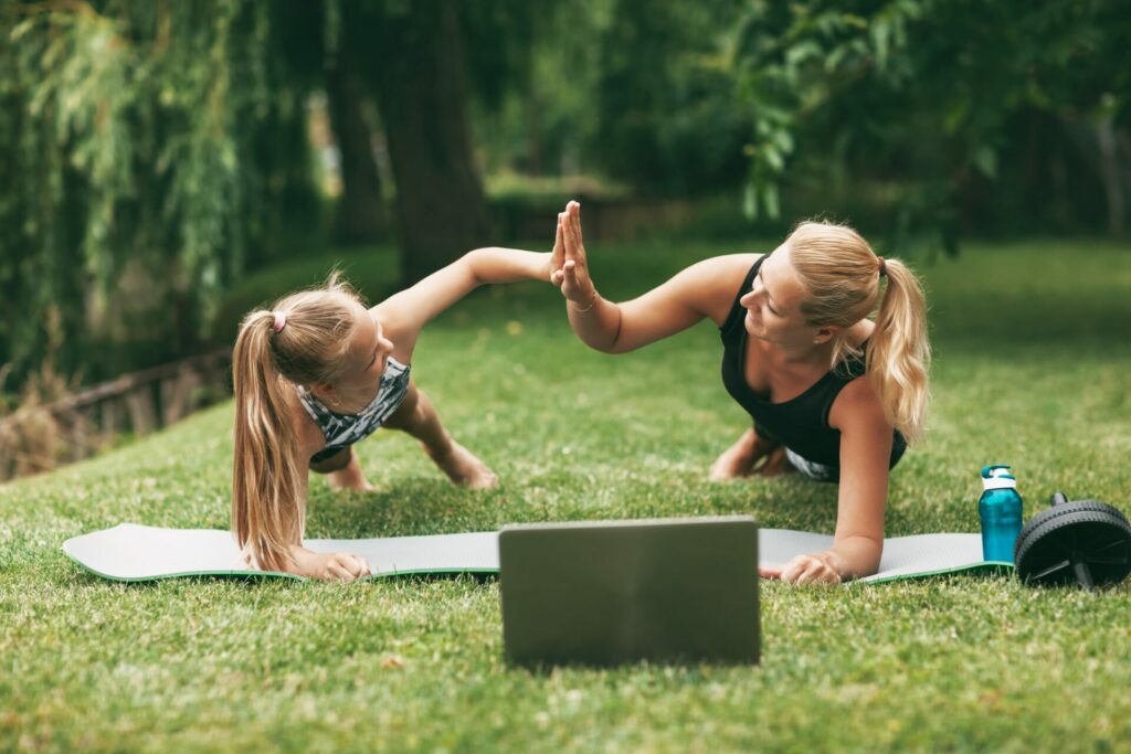 Mother and daughter practice online outdoors near their home during quarantine